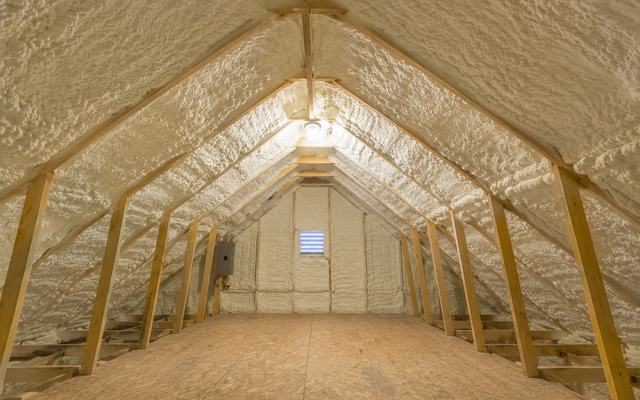 Spray foam insulation sprayed under the roof rafters of an attic in Woodstock